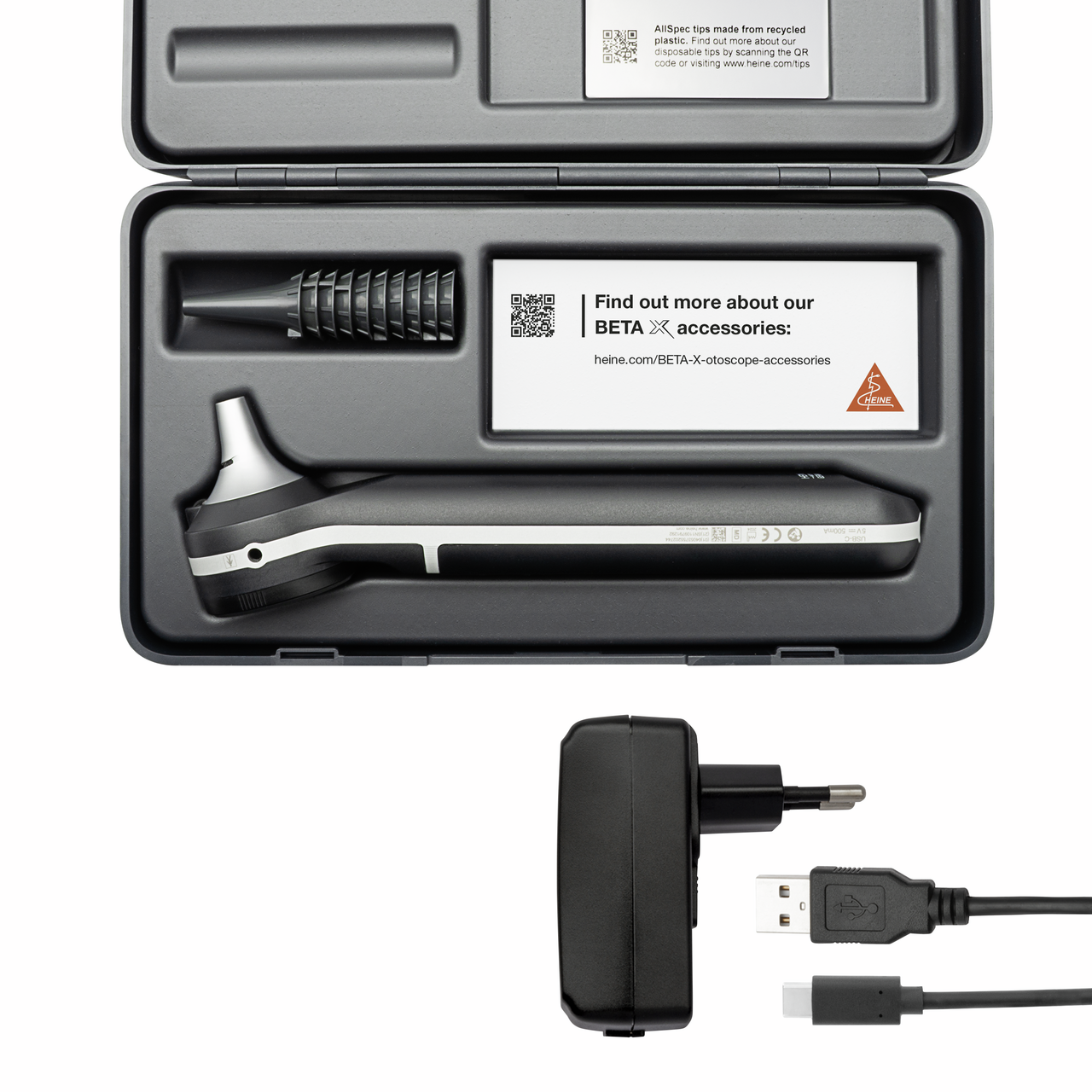 The image shows a HEINE BETA X otoscope set, featuring a sleek, metallic otoscope with a black handle, neatly placed in a protective case. The set includes a charger and USB cables, ideal for medical professionals.